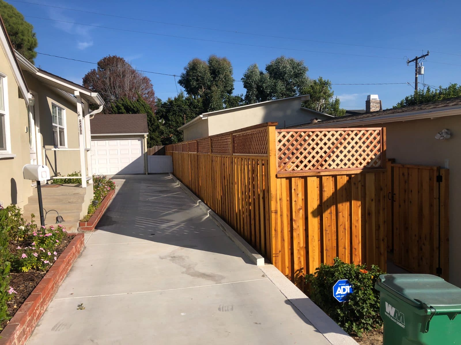 New concrete driveway and custom cedar fence
